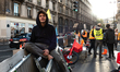 A young activist from Extinction rebellion sits on the barricade blocking traffic on Rivol...