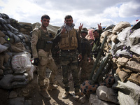 Members of the Kurdish Peshmerga forces, PKK and YPG fighting for retaking the Sinjar City from ISIS, on March 23, 2015. (