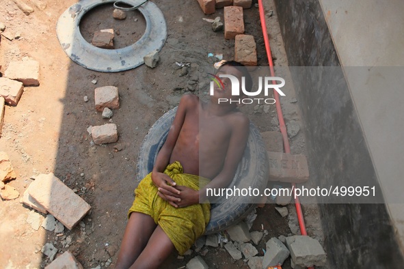 A child laborer who works only for BDT 150 ( $1.8) having rest in a brick field of Rajendrapur near Dhaka, Bangladesh, 24 March, 2015. 