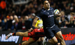   Sinoti Sinoti of Newcastle Falcons evades a last despairing tackle to score during the G...