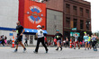 Runners pass rival Coney Island restaurants on Washington Avenue during the Detroit Free P...