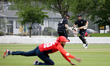 Tim Seifert (R) and Colin Munro of New Zealand XI run between the wickets during the first...