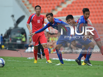 Ri Hyong Jin of DPR Korea (R) fight for the ball with Cambodia players during the AFC U-23 Championship 2016 qualifiers round at Rajamangala...