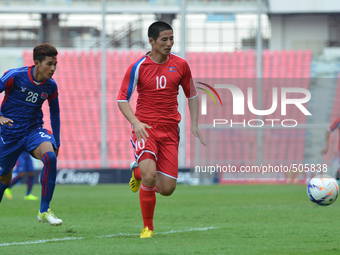 Kim Ju Song of DPR Korea (R) is closed down by Rous Samoeun of Cambodia during the AFC U-23 Championship 2016 qualifiers round at Rajamangal...