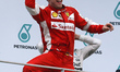 German Sebastian Vettel of Scuderia Ferrari celebrates on a podium after won the Malaysian...