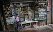 A vendor waits for customers at his shop selling photo frames in Mumbai, India on 08 Novem...