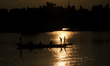Workers in a boat for cleanings weeds and unwanted plants from the water of Holy pond Bind...