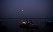 On the eve of Dev Deepawali, people capture a picture while they rides a boat on a Hindu r...
