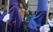 People crying and Hooded members of the "Nuestro padre Jesús Nazareno El Pobre" brotherhoo...