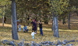 Visitors play with autumn leaves at Golden Village Open Air Museum in Ankara, Turkey on No...