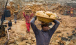 Workers are carrying stones outside of the stone extraction site on April 4, 2015 in Jaflo...