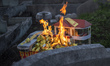 A car and bungalow paper replica is burn during the Qingming festival at a cemetery in Kua...