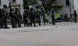 Soldiers stand guard at Bolivar Square in downtown Bogota on November 23, 2019, following...