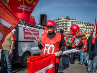 A FO member demonstrator holding a FO flag during a protest as part of a national mobilization against the government's austerity measures a...