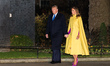 US President Donald Trump and First Lady Melania Trump walk in Downing Street to attend a...