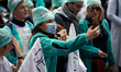 A urse uses her smartphone to film the demo. Between 60 and 80000 protesters took to the s...