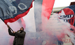 A fan of Cosenza Calcio waves a flag outside the court of Cosenza during the protest "trut...
