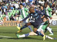 Porto's Algerian midfielder Yacine Brahimi kicks the ball and Rio Ave's Brazilian defender Lionn during the Premier League 2014/15 match bet...