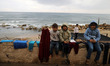 Palestinian children play by the beach, near the site of Israeli overnight attacks in Gaza...