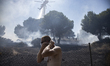 Firefighters operate to extinguish a wildfire at the area of Rafina, near Athens, on July...