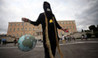 A protester wearing a gas mask holding an earth shaped lantern during protest rally by env...