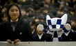 Schoolchildren pose for a picture with Tokyo 2020 Olympic Games' robot-type mascot Miraito...