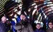 Ukrainians watch on a screen a press-conference of the Normandy Four leaders, during a ral...
