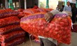 Workers carry sack of onions at Muhana Vegetable Market, in Sanganer near Jaipur, Rajastha...
