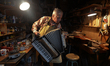 Former theatre actor and long time artist and luthier, Jozef Gmyrek (age 71), tunes an acc...
