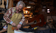Former theatre actor and long time artist and luthier, Jozef Gmyrek (age 71), repairs a gu...