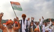 Supportes hold Congress Flag as they listen to the speakers during the mega rally Bharat B...