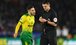 Referee Andrew Madley shows a yellow card to Emi Buendia (17) of Norwich City during the...