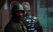 Amid snowfall Indian paramilitary soldiers stand alert during Friday congregation prayers...