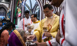 Myanmar Christian devotee receives a holy communion during a Christmas Eve mass at St. Mar...