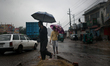 People make their move during a light rain in  Dhaka, Bangladesh on 03 January 2020.    
