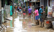 Residents began cleaning mud and furniture affected by floods as high as 5 meters in the r...
