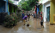 Residents began cleaning mud and furniture affected by floods as high as 5 meters in the r...