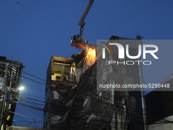  The evacuation team cut down the 5-story collapsed concrete part of the building in the Slipi area, Jakarta, in January, 6.2020. Allegedly...