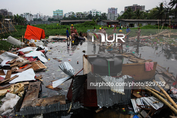 Firefighters are trying to rescue the missing people after collapse of  two storied tin-shed house on swampy ground at Hajipara Jheel, Dhaka...