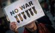 Demonstrators from the group 'No War' take part in a protest against military conflict bet...