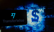 The logo of TransferWise is seen on a screen of a smartphone next to an illustration of mo...