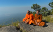 Two buddhist monks enjoy a view from Wat Sampov Pram at the very top of Phnom Bokor in Bok...