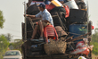 A group on men transported on a track seen on the road between Kep City and Kampong Trach....