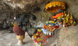 A view of Buddha statue inside a cave in Phnom Kampong Tranch.  The roof of a large cave...