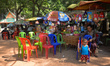 A view of a souvenir shops and local restaurants near the entrance to Kampong Trach Mounta...