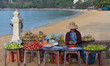 A woman sells local fruits at the seafront near the White Lady Statue in Kep City.On Tues...