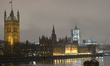 A night view of Westminster Palace and Big Ben covered in scaffolding during renovation wo...