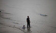 Palestinian families swim and palestinian youth jumps into the Mediterranean Sea as he enj...