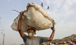 A Indian man with recyclable materials in a dumping site on the eve of World Earth Day in...