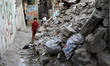 Palestinian girl walking near house rubble destroyed by Israeli warplanes in 2014 51 days...